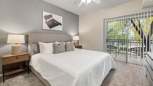 a bedroom with a white bed and a window at Landing - Modern Apartment with Amazing Amenities (ID7762X30) in Leisure World