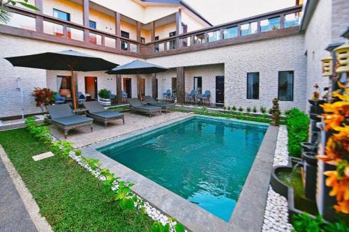 a swimming pool in the backyard of a house at Serendipity Bali in Sanur