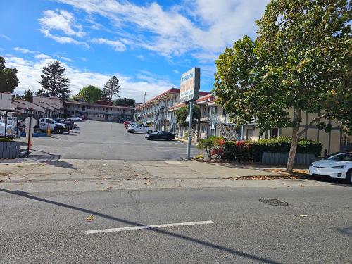 an empty street in a town with cars parked at Terrace Inn and Suites in El Cerrito