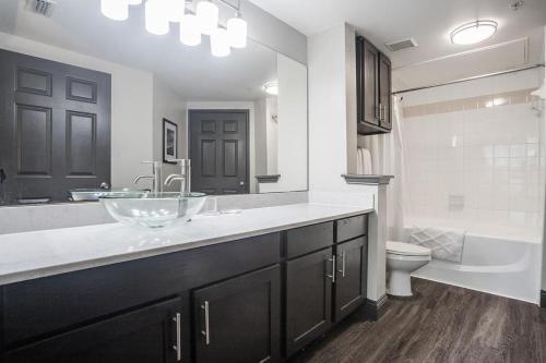 y baño con lavabo, bañera y aseo. en Landing - Modern Apartment with Amazing Amenities (ID4583X64) en Houston