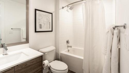 a white bathroom with a sink and a toilet at Landing - Modern Apartment with Amazing Amenities (ID748) in Fort Lauderdale