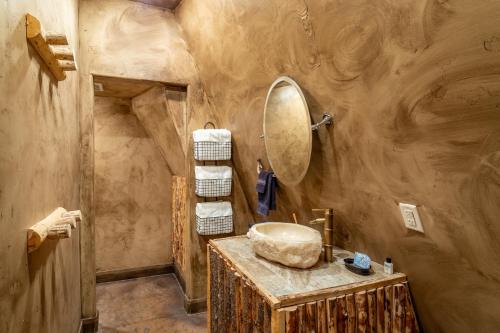 a bathroom with a sink and a mirror and towels at Zion White Bison Glamping & RV Resort in Virgin