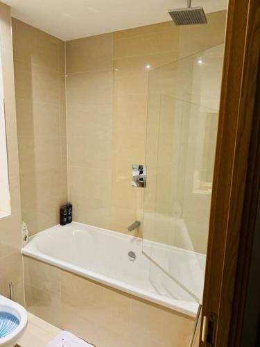 a bathroom with a white tub and a toilet at Play Away Lodge in Basildon