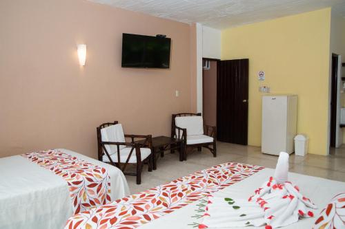 Ένα ή περισσότερα κρεβάτια σε δωμάτιο στο Hotel Zihua Caracol