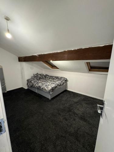 an attic room with a bed in a room at Huddersfield house in Huddersfield