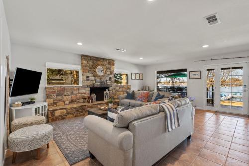 a living room with two couches and a fireplace at Family Lakefront Retreat in Granite Shoals