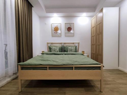 a bedroom with a large bed in a room at Antonia's Cozy Studio in Ştefăneştii de Jos