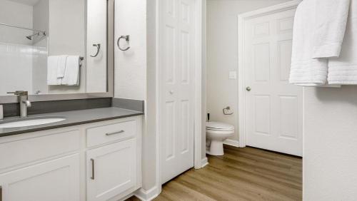 a white bathroom with a sink and a toilet at Landing - Modern Apartment with Amazing Amenities (ID1374X809) in Charlotte