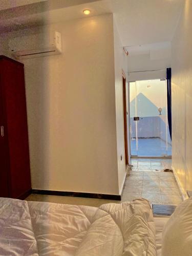 a bedroom with a bed and a door to a balcony at Enjoy Giza Pyramids View in Cairo
