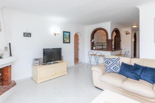 a living room with a couch and a tv at Spacious 3BR in Miraflores near all amenities in Málaga