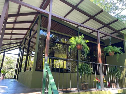 a screened in porch with potted plants on it at Caba&ntilde;as La Monta&ntilde;a Mountain Lodge in Monteverde Costa Rica
