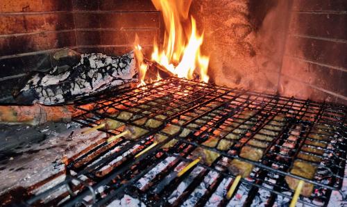 a grill with fire in a brick oven at Your Spot West Peloponnese in Zakharo