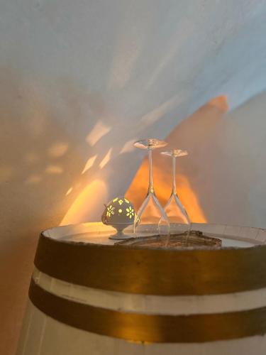 a table with two wine glasses on top of it at Arquati Suite Luxury Apartment in Ostuni