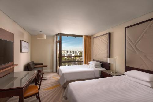 a hotel room with two beds and a large window at Lisbon Marriott Hotel in Lisbon