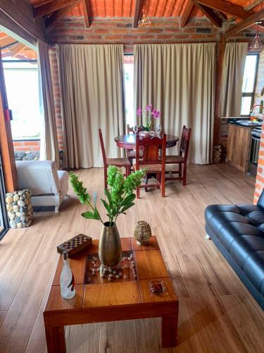 a living room with a couch and a table at Pumamaki EcoLodge Glamping in Quito