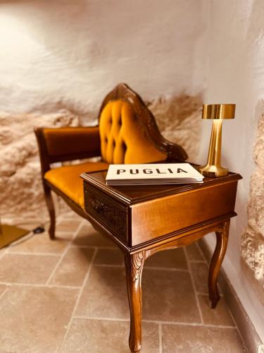 a wooden table with a lamp on top of it at Arquati Suite Luxury Apartment in Ostuni