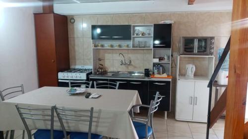 a kitchen with a table and chairs in a room at Aires de Montaña in Malargüe