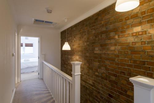 a brick wall in a hallway with a staircase at London House in London