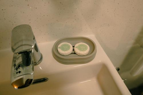 a bathroom sink with two candles sitting on it at Granary at Tyddyn Isaf in Ruthin