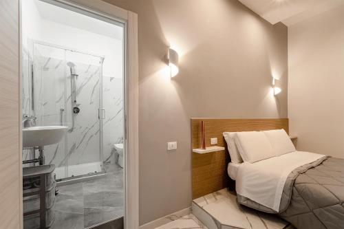 a bedroom with a bed and a sink and a shower at TERMINI HOLIDAY in Rome