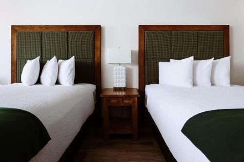 two beds sitting next to each other in a hotel room at Taos Valley Lodge in Taos