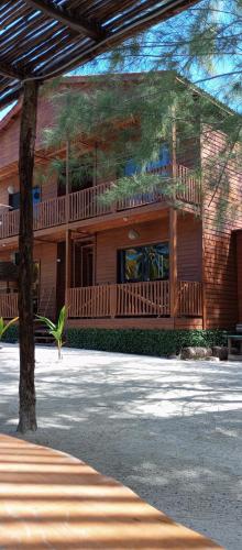 a large wooden house with a large balcony at El Regalo El Cuyo in El Cuyo
