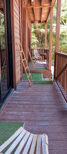 a porch of a cabin with wooden steps and windows at El Regalo El Cuyo in El Cuyo