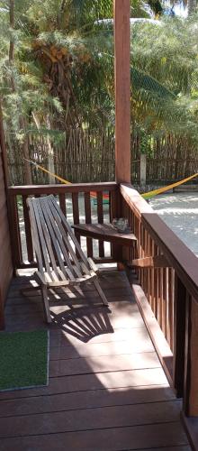 a wooden bench sitting on a wooden porch at El Regalo El Cuyo in El Cuyo