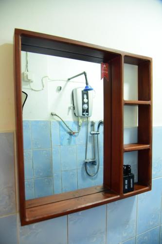 a shower in a bathroom with blue tiles at Villa Sunny Days in Hikkaduwa