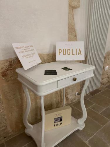 a white table with two boxes on top of it at Arquati Suite Luxury Apartment in Ostuni