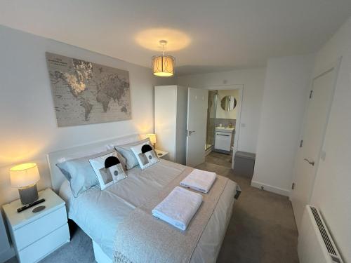 a bedroom with a bed with two towels on it at Apartment in Ashford with Large Terrace in Ashford