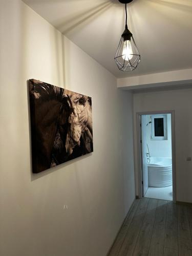 a painting hanging on a wall in a room at Best Apartment Suceava in Suceava
