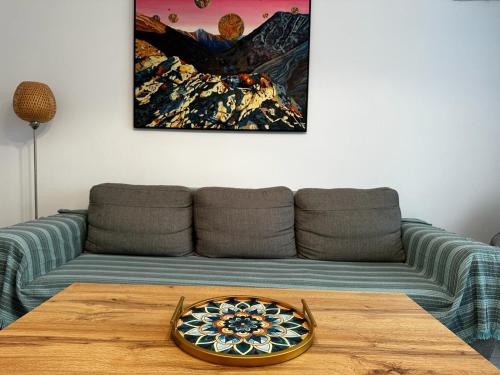 a living room with a couch and a wooden table at Best Apartment Suceava in Suceava