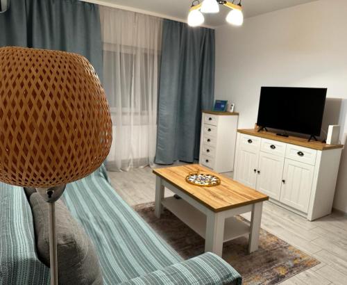 a living room with a television and a table at Best Apartment Suceava in Suceava
