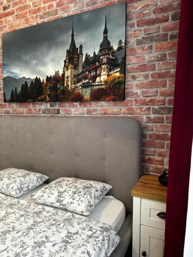 a bedroom with a castle painting on the wall at Best Apartment Suceava in Suceava