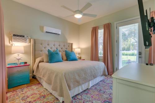 a bedroom with a bed with blue pillows and a window at Riverfront Florida Studio with Pool and Hot Tub Access in La Belle
