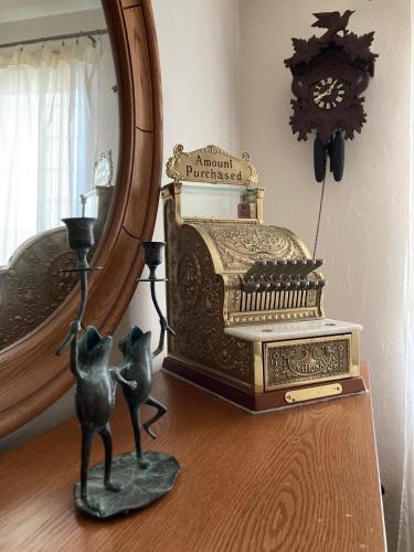 a mirror and a statue on a table next to a toaster at Cozy Algoma Retreat! Minutes to Beach and Downtown! in Algoma