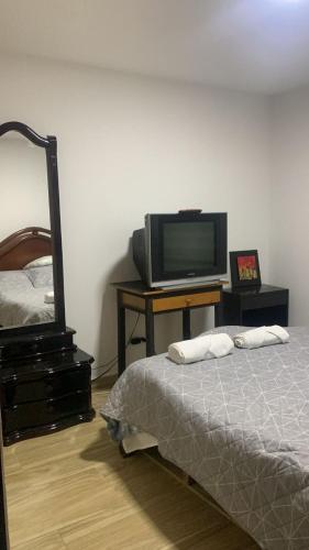a bedroom with a bed and a tv on a table at San fason 3 in Bogotá