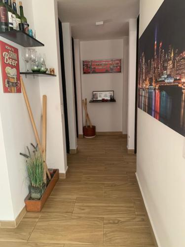 a hallway with wooden floors and paintings on the walls at San fason 3 in Bogotá