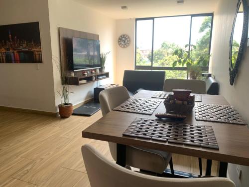 a dining room with a table with a keyboard on it at San fason 3 in Bogotá