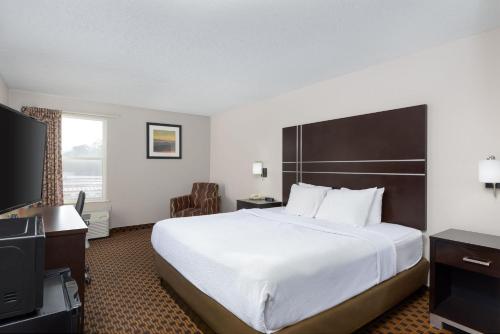 a hotel room with a large bed and a television at Stay 2Night Chattanooga Hamilton Place in Chattanooga