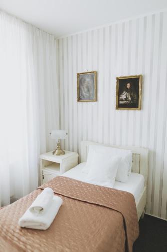 a bedroom with a bed with two towels on it at Penzion Jakub in Lanškroun
