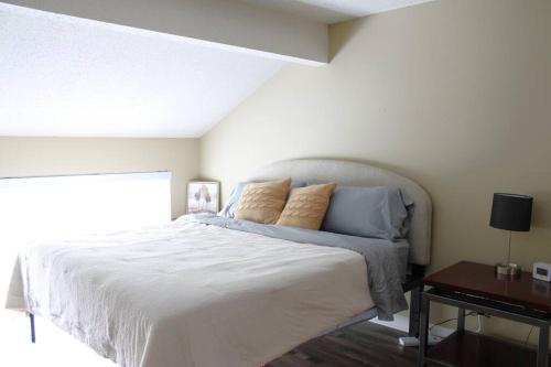 a bedroom with a large white bed with pillows at Condo in Downtown Little Rock in Little Rock