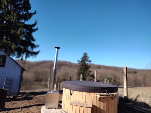 a wooden barrel sitting on top of a field at Marókahegy in Zalakaros