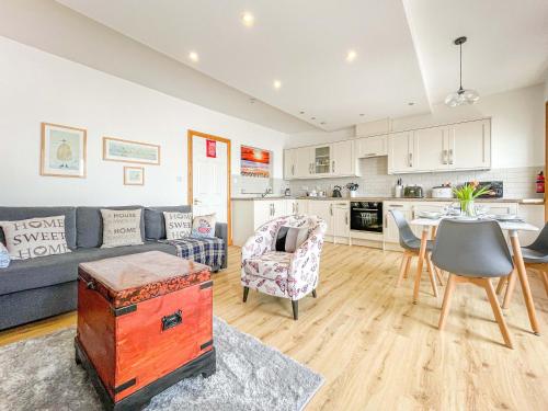 a living room with a couch and a table at Bay Retreat - Esplanade sea views parking in Weymouth