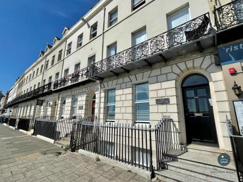 a building with a balcony on the side of it at Bay Retreat - Esplanade sea views parking in Weymouth