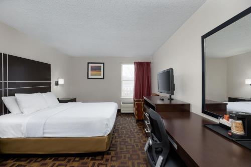 a hotel room with a bed and a flat screen tv at Stay 2Night Chattanooga Hamilton Place in Chattanooga