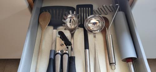 a bunch of kitchen utensils are in a drawer at Casa Estulio in Pontey