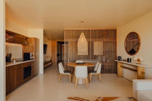 a kitchen and dining room with a table and chairs at Nobu Hotel Los Cabos in Cabo San Lucas