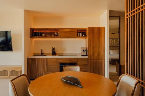 a dining room with a table and a kitchen at Nobu Hotel Los Cabos in Cabo San Lucas